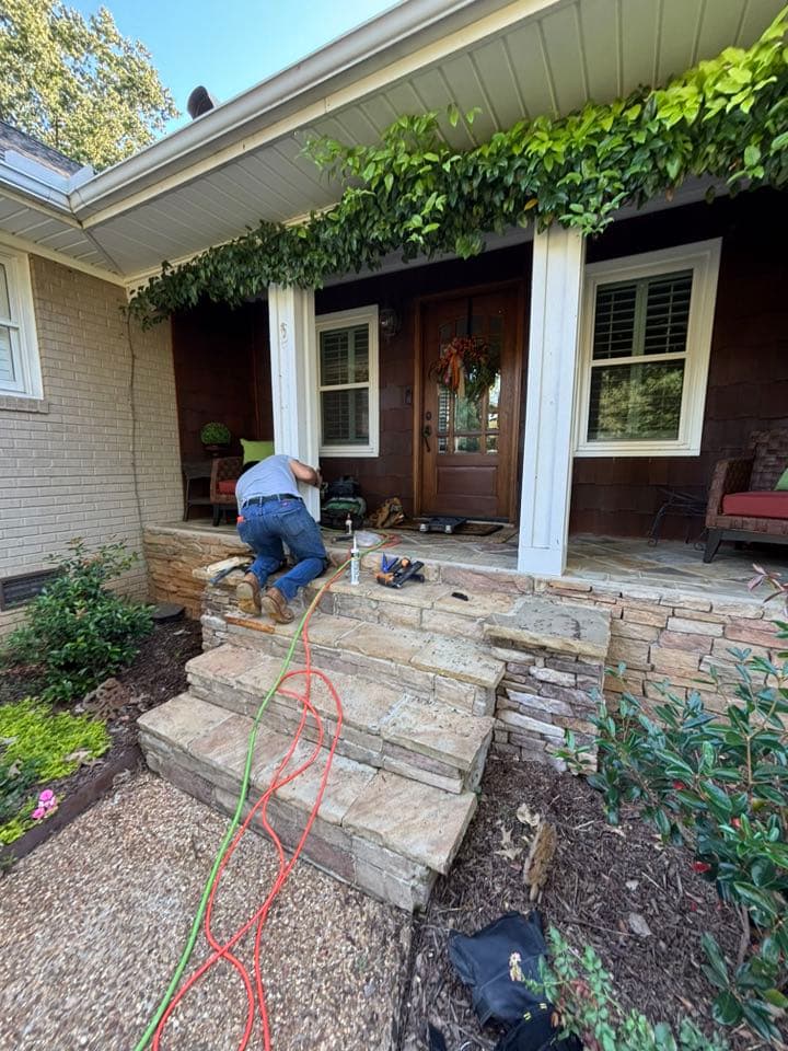 Contractor building a pillar for a front porch entryway at a residential home.